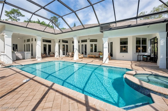 view of swimming pool with an outdoor kitchen, a lanai, an in ground hot tub, and a patio