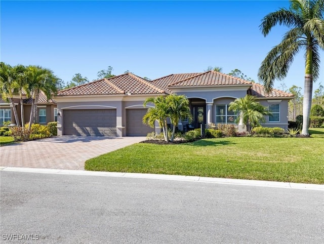 mediterranean / spanish-style home with a front yard and a garage