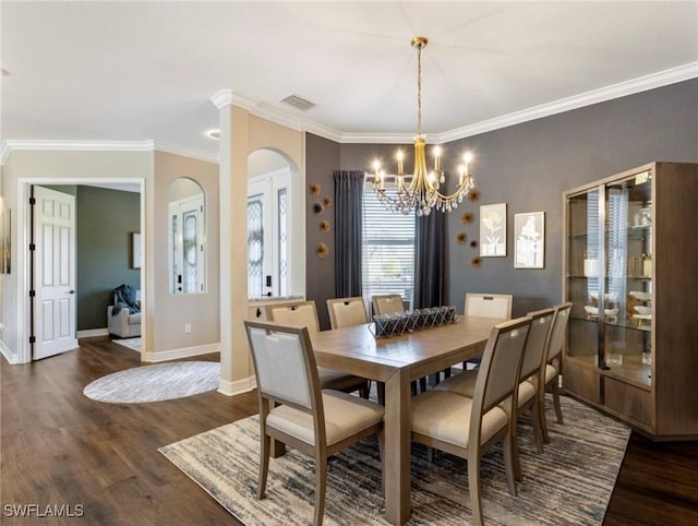 dining area featuring ornamental molding, dark hardwood / wood-style floors, and a notable chandelier