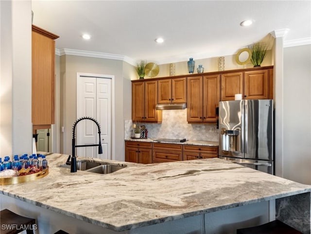 kitchen with stainless steel refrigerator with ice dispenser, backsplash, sink, and crown molding