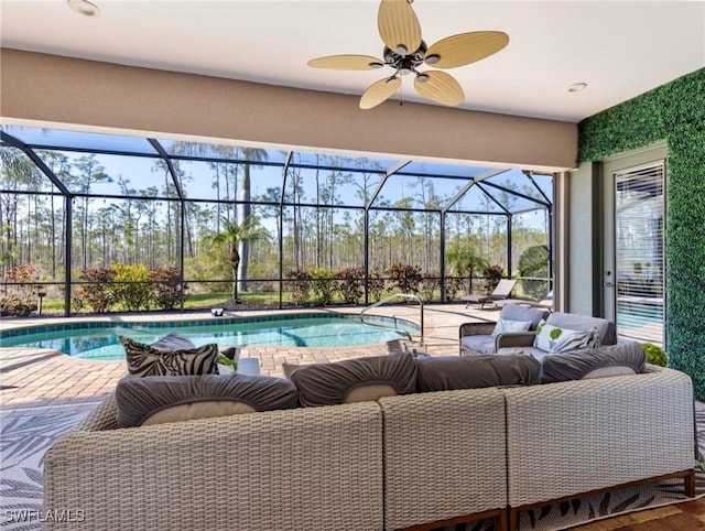 view of pool featuring ceiling fan, a patio area, outdoor lounge area, and a lanai