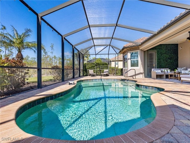 view of swimming pool featuring ceiling fan, an outdoor living space, a patio, and glass enclosure