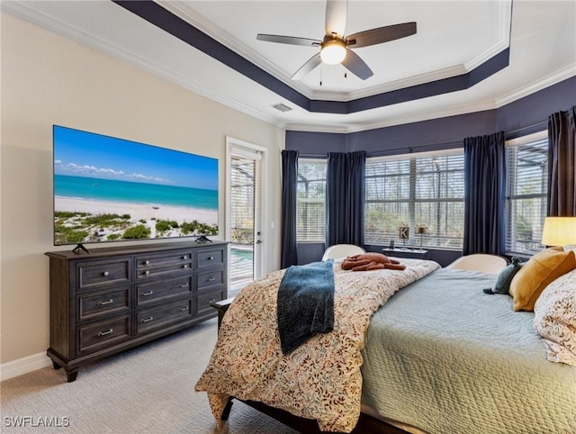 carpeted bedroom featuring ceiling fan, access to outside, a tray ceiling, and ornamental molding