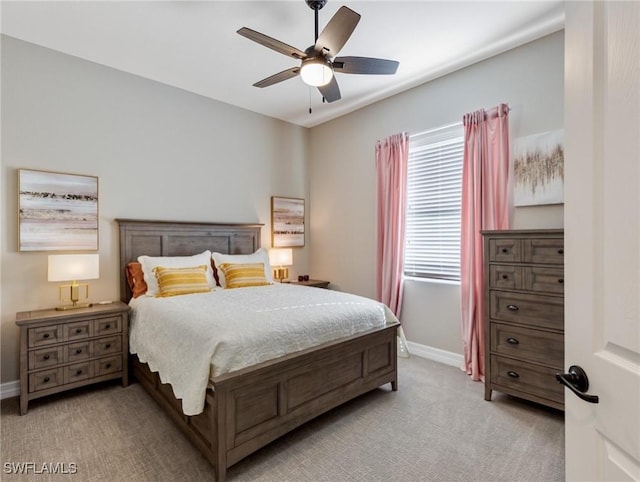 bedroom featuring ceiling fan and light carpet