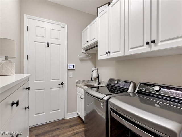 laundry area with independent washer and dryer, dark hardwood / wood-style flooring, sink, and cabinets