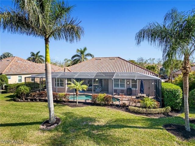 back of property featuring a lanai and a yard