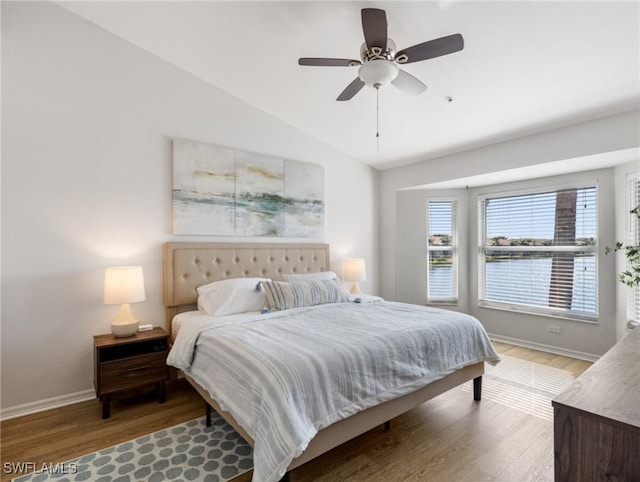 bedroom featuring vaulted ceiling, wood-type flooring, and ceiling fan