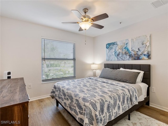 bedroom with hardwood / wood-style flooring and ceiling fan