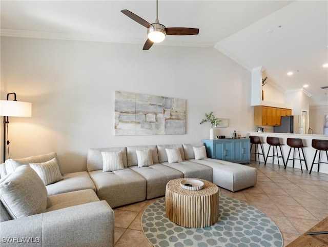 living room with ornamental molding, lofted ceiling, and light tile patterned floors