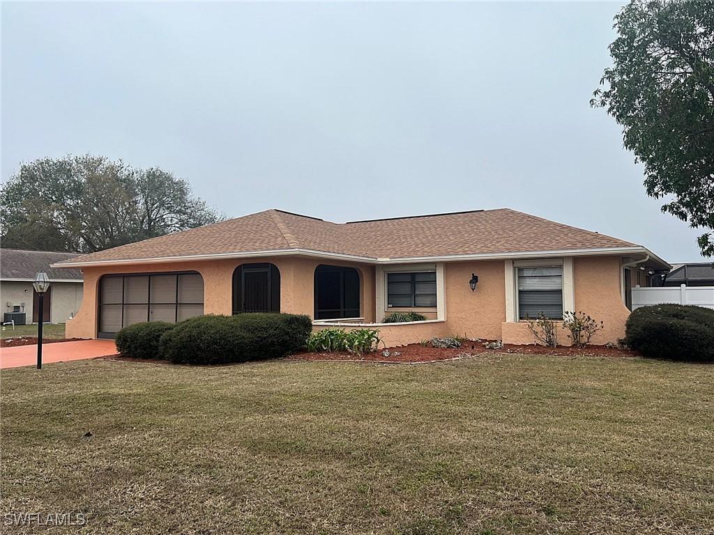 ranch-style house with a front lawn and a garage