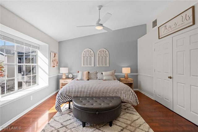 bedroom with ceiling fan, dark hardwood / wood-style flooring, and a closet