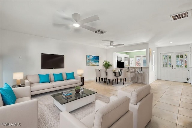 tiled living room with ceiling fan