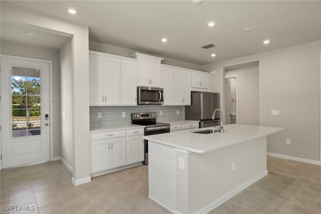 kitchen featuring a kitchen island with sink, sink, white cabinetry, and stainless steel appliances