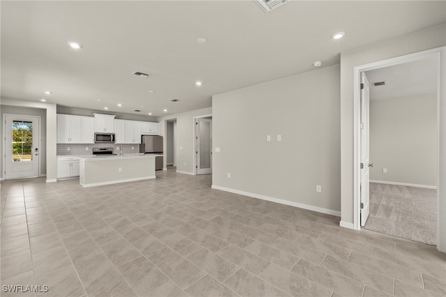 unfurnished living room featuring light tile patterned floors