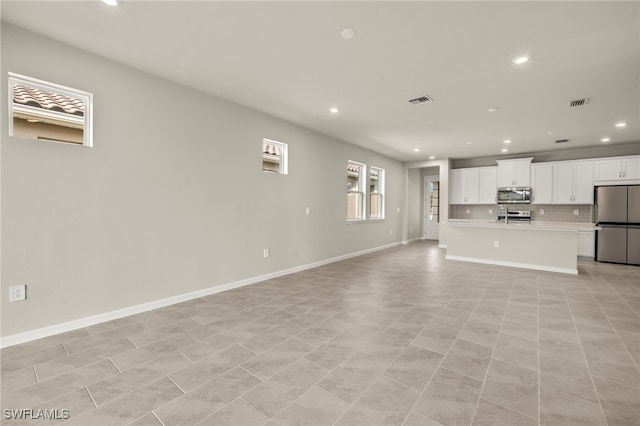 unfurnished living room with light tile patterned floors