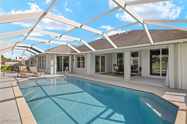 view of swimming pool with a lanai and a patio