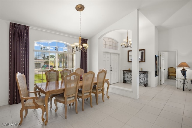 tiled dining area with an inviting chandelier and vaulted ceiling