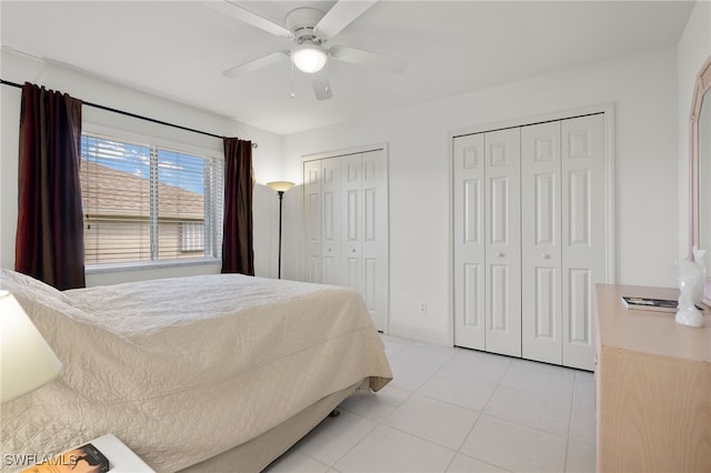 tiled bedroom with multiple closets and ceiling fan