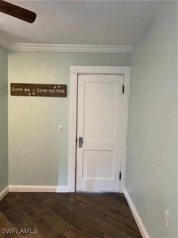 hallway featuring ornamental molding and dark hardwood / wood-style floors