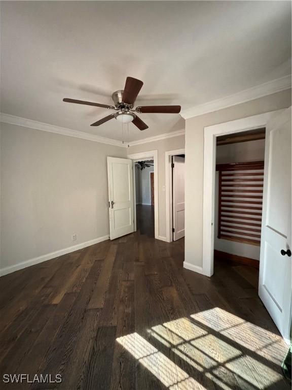 unfurnished bedroom featuring dark hardwood / wood-style flooring, a closet, ceiling fan, and crown molding