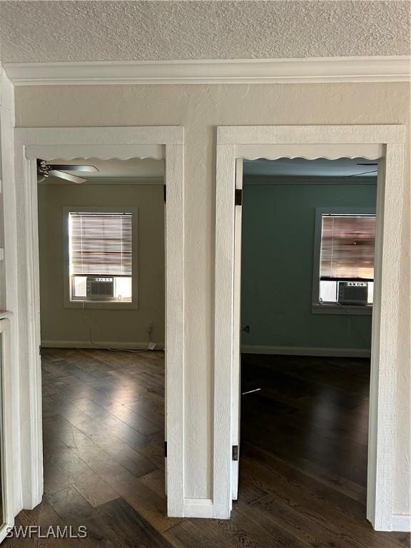 corridor featuring crown molding and dark wood-type flooring