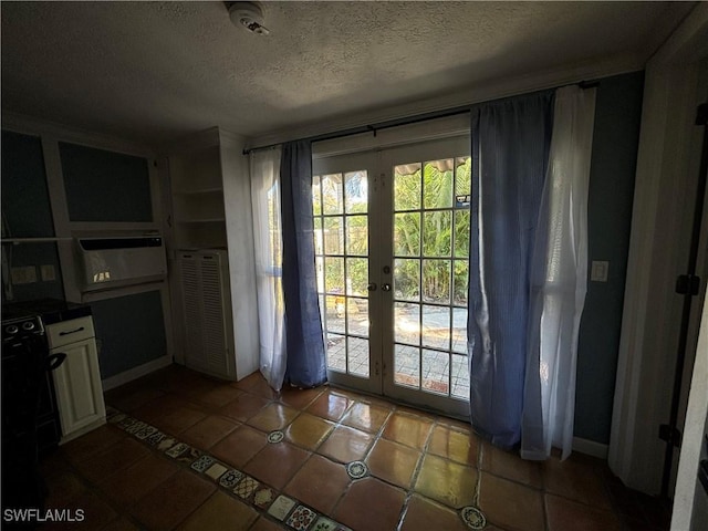 doorway with french doors, tile patterned flooring, and a textured ceiling