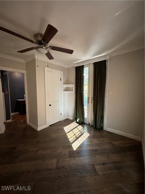 unfurnished bedroom featuring ceiling fan, ornamental molding, and dark hardwood / wood-style floors