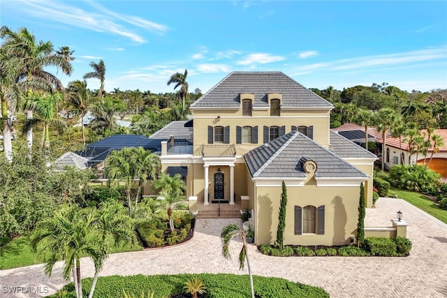 french country inspired facade featuring a balcony and a lanai