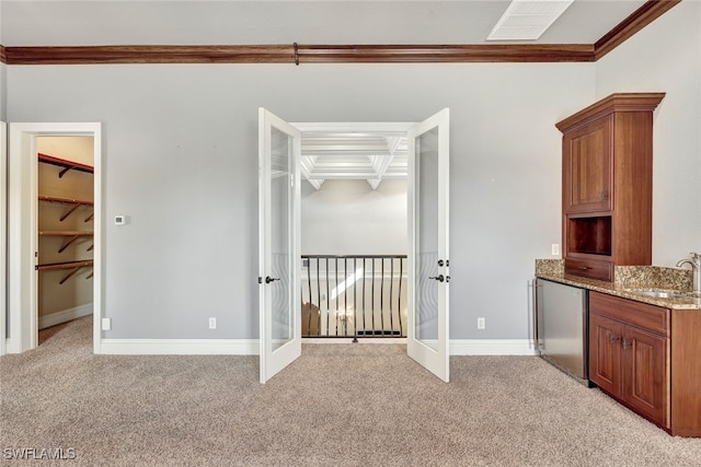 interior space with crown molding, light colored carpet, and french doors