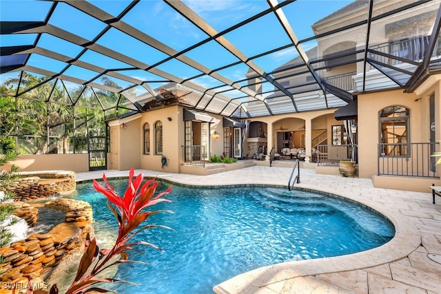 view of swimming pool with a lanai and a patio area