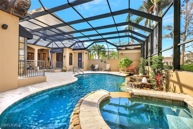 view of swimming pool featuring an in ground hot tub, a lanai, and a patio