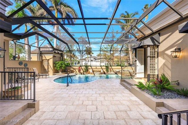 view of swimming pool featuring a patio, pool water feature, and glass enclosure