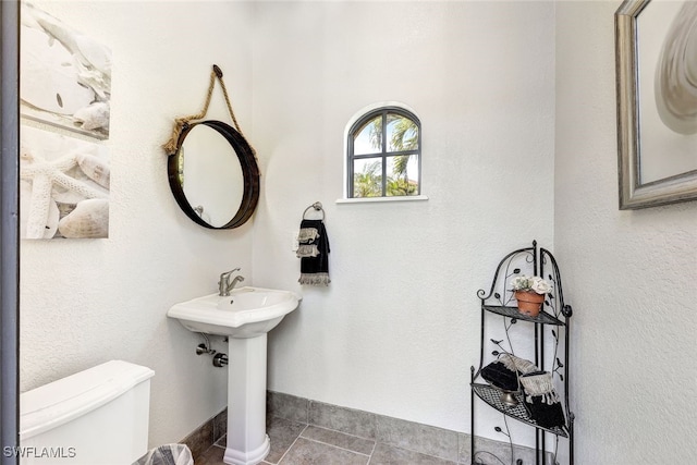 bathroom featuring tile patterned flooring and toilet