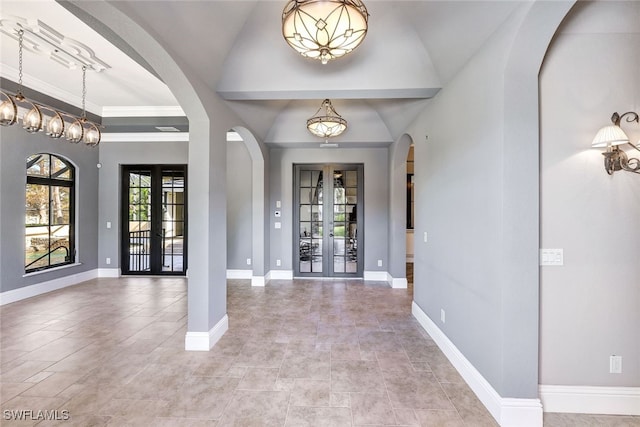 foyer entrance with french doors and vaulted ceiling