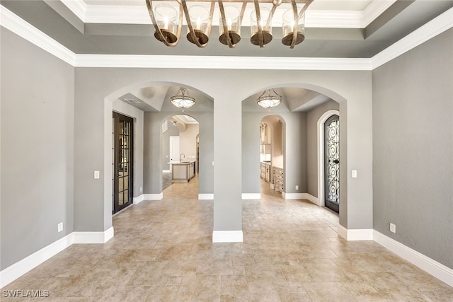 entryway featuring crown molding and a tray ceiling