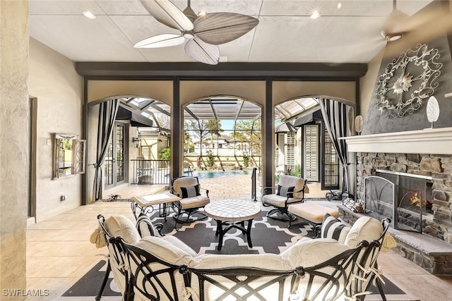 view of patio featuring ceiling fan and an outdoor stone fireplace