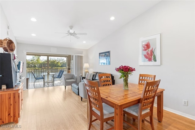 dining room featuring vaulted ceiling, ceiling fan, and light hardwood / wood-style flooring