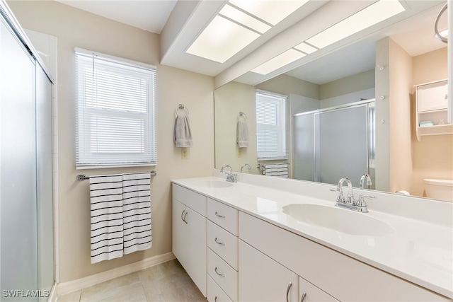 bathroom featuring vanity, an enclosed shower, tile patterned flooring, and plenty of natural light