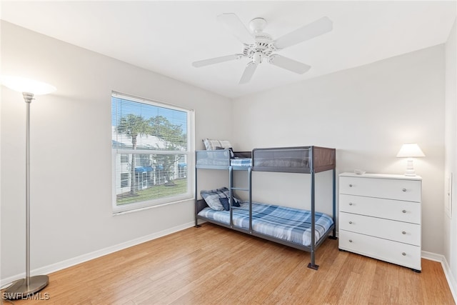 bedroom with ceiling fan and light hardwood / wood-style floors