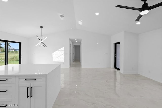 interior space with decorative light fixtures, white cabinetry, and ceiling fan