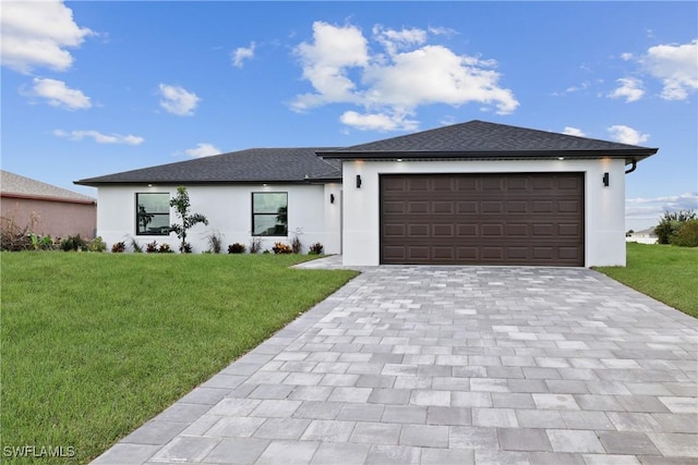 view of front of property with a front lawn and a garage