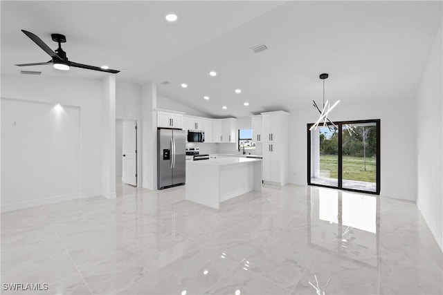 kitchen featuring stainless steel appliances, ceiling fan, decorative light fixtures, a center island, and white cabinetry