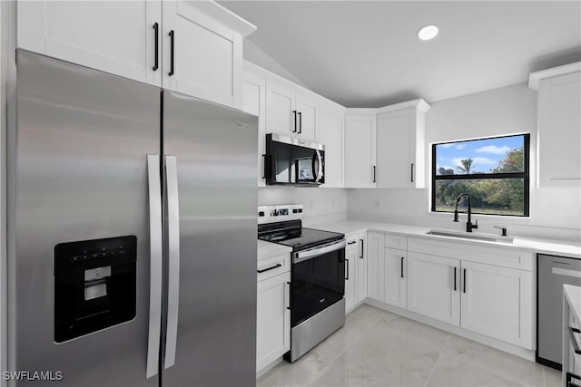 kitchen featuring white cabinets, stainless steel appliances, and sink