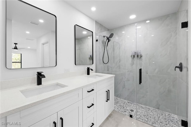 bathroom featuring ceiling fan, a shower with door, and vanity