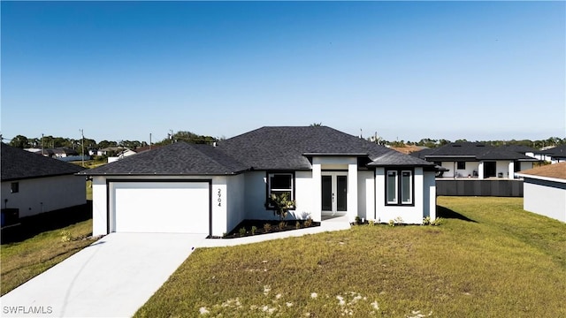 view of front of house with a garage, french doors, and a front yard