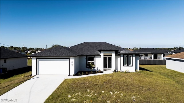 prairie-style home with french doors, a front lawn, and a garage