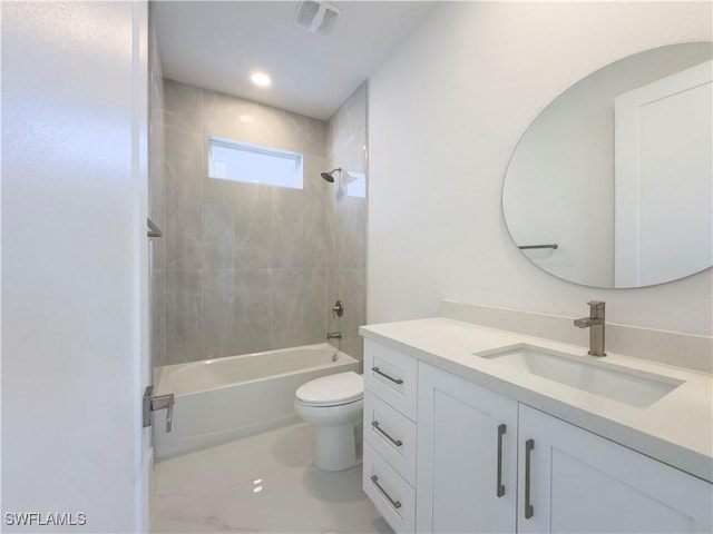 full bathroom with vanity, tiled shower / bath combo, and toilet