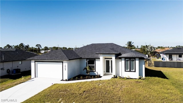 view of front of home with a garage, central AC, and a front yard