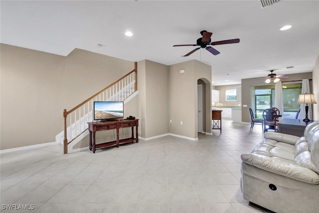 living room with light tile patterned flooring and ceiling fan