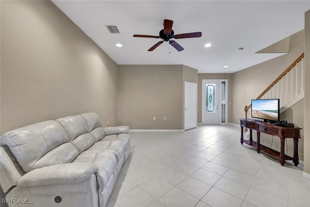 tiled living room with ceiling fan